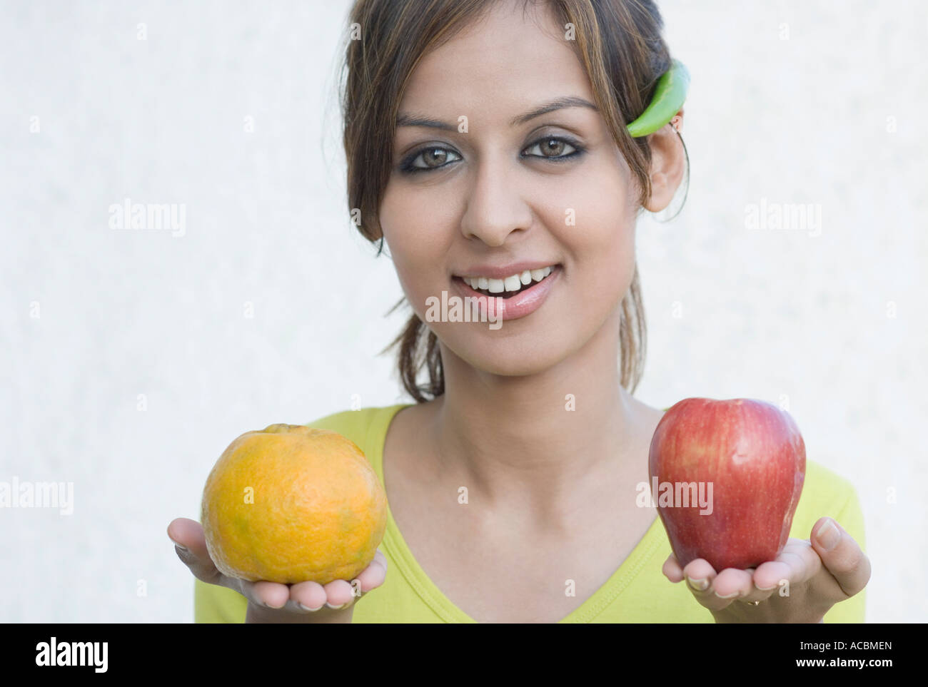 Portrait of a young woman holding fruits Stock Photo - Alamy