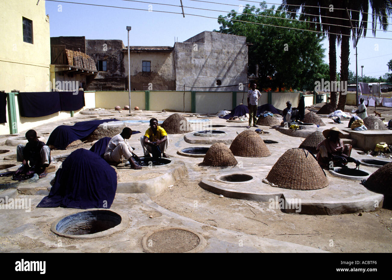 Boy working in the dye pits of Kano Nigeria West Africa Stock