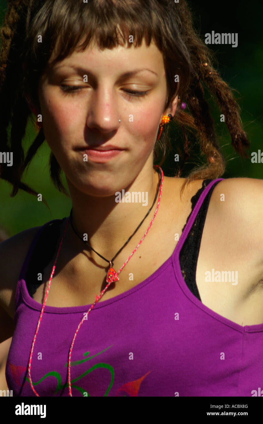 Slender teenage girl in violet singlet dancing at rave party Hilltop ...
