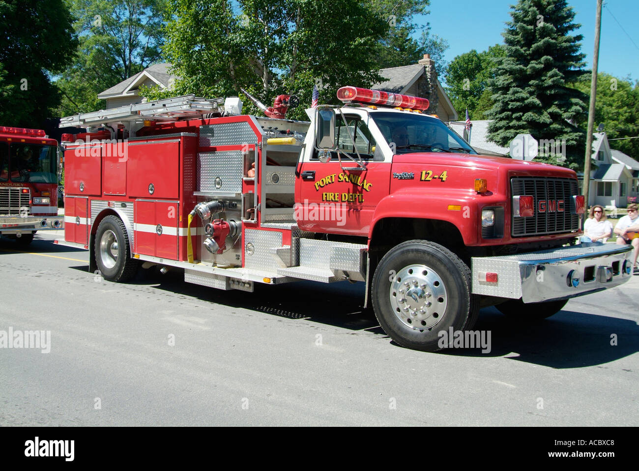 Current and vintage historic fire trucks at Independence Day parade at Lexington Michigan Stock
