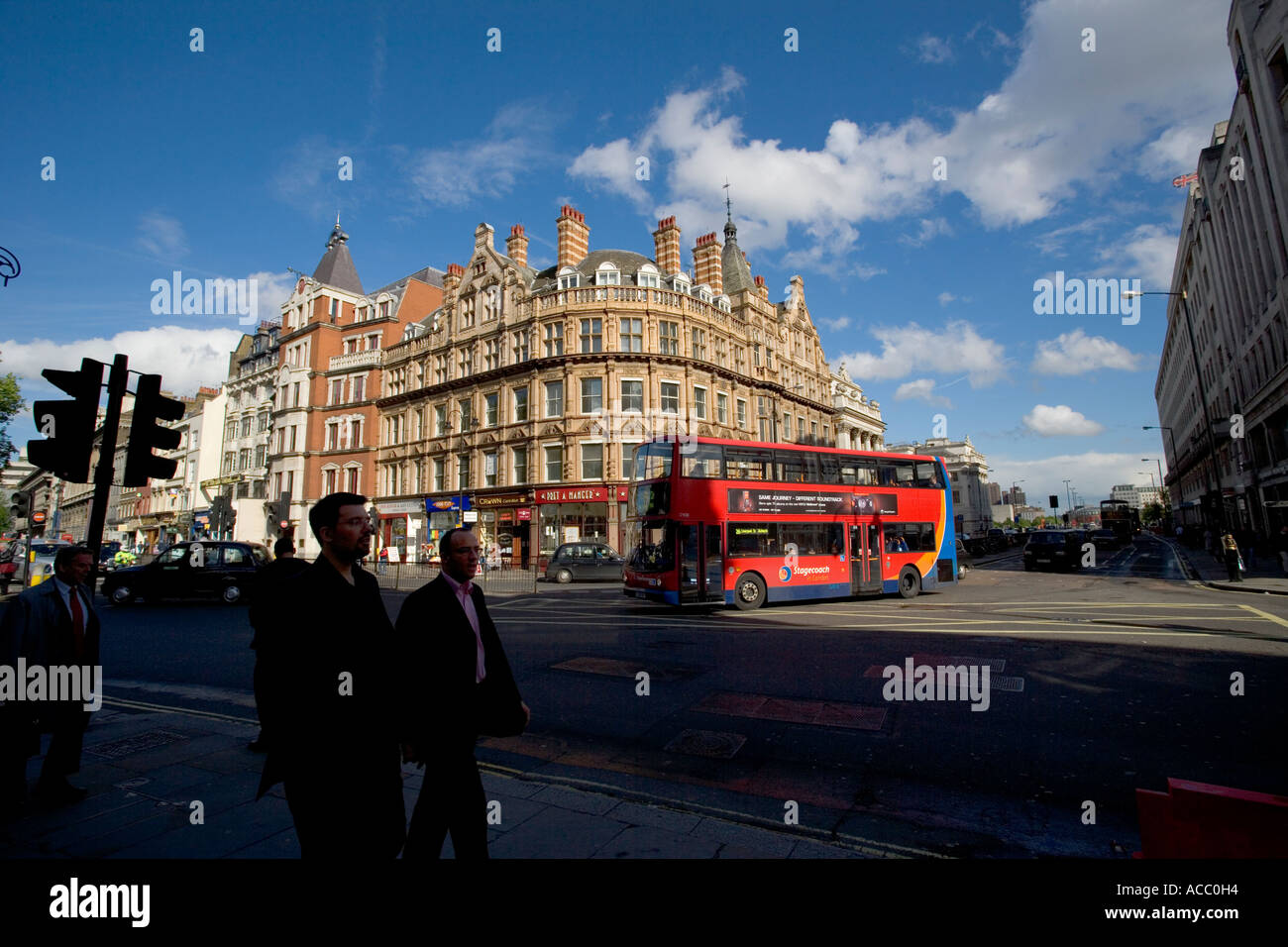 Pedestrians and Red Bus along the Strand in London England UK Stock Photo