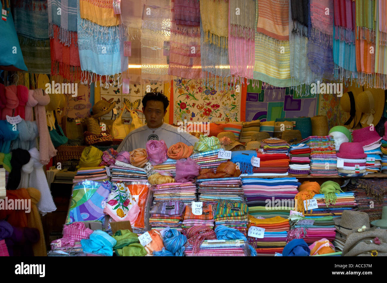 Market stall and vendor with scarves Florence Italy Stock Photo Alamy