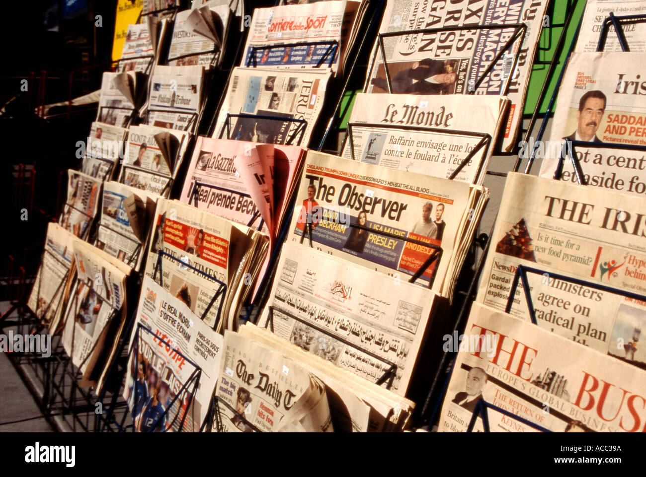 Foreign and domestic newspapers on newsstand rack Stock Photo