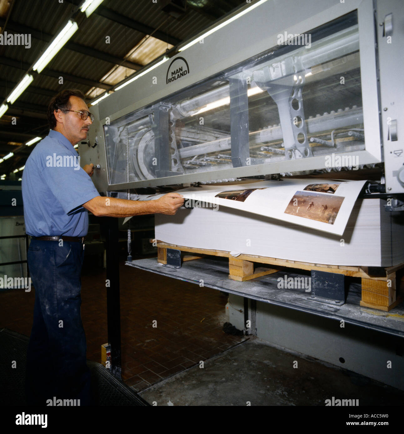 Man Pulling Pages Of Modern Printing Press Butler And Tanner Printers