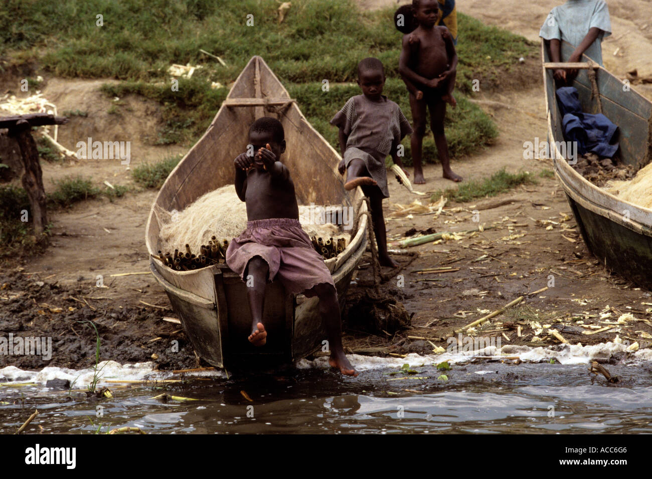 Children playing on fishing boats, Uganda Stock Photo