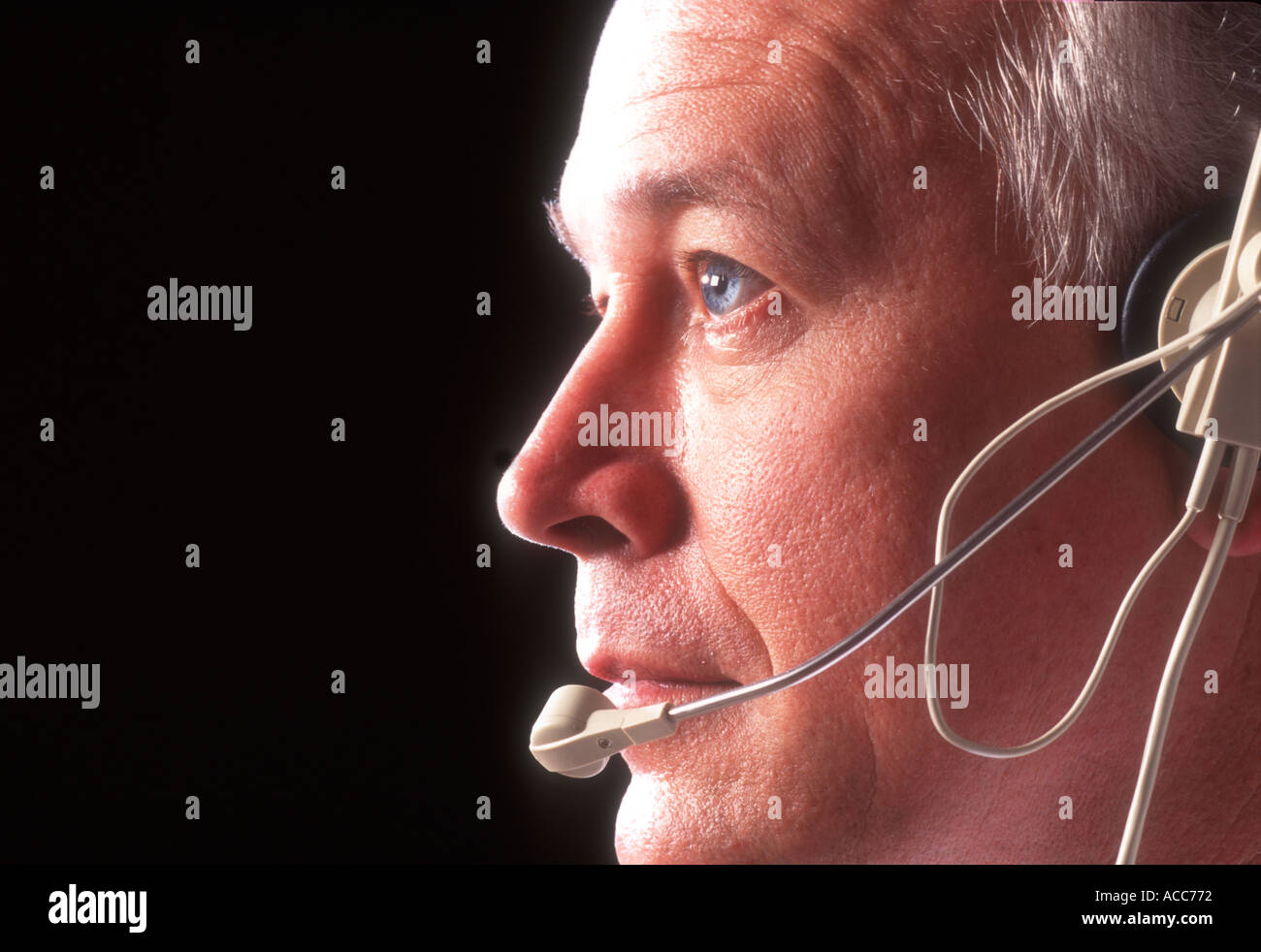 male telemarketer working with headset telephone Stock Photo