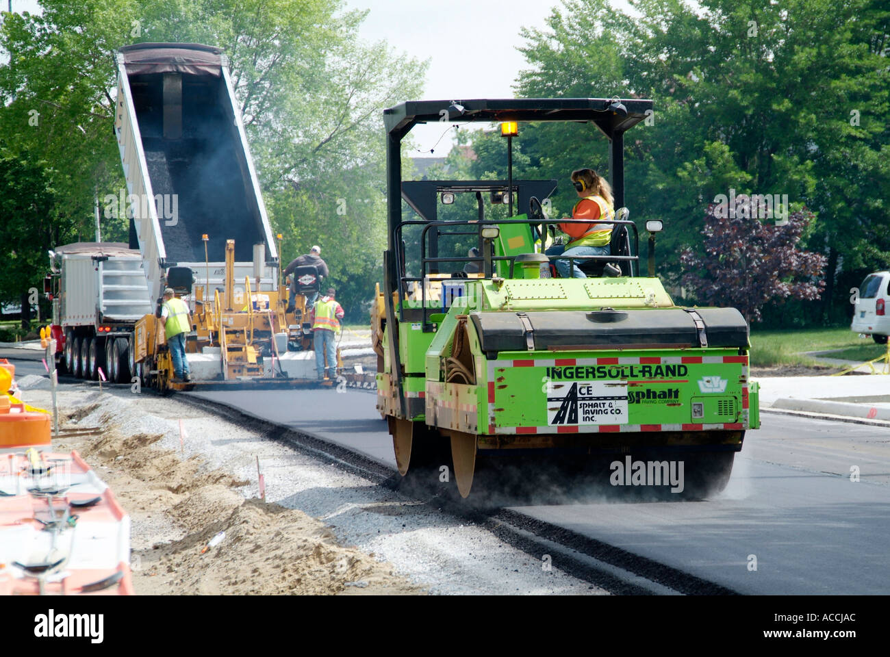 Steam roller Construction crew creates new asphalt street Stock Photo