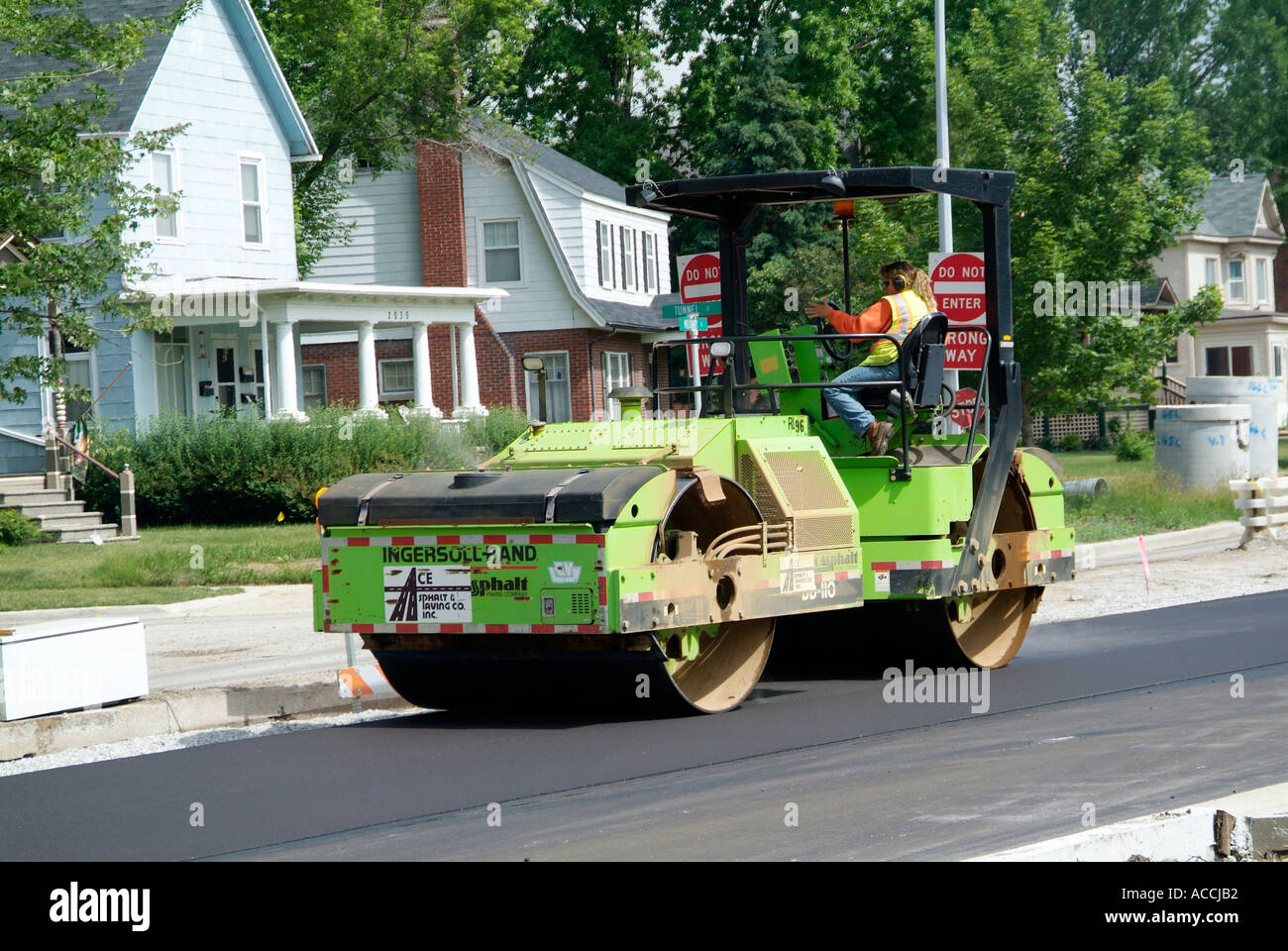 Steam roller Construction crew creates new asphalt street Stock Photo