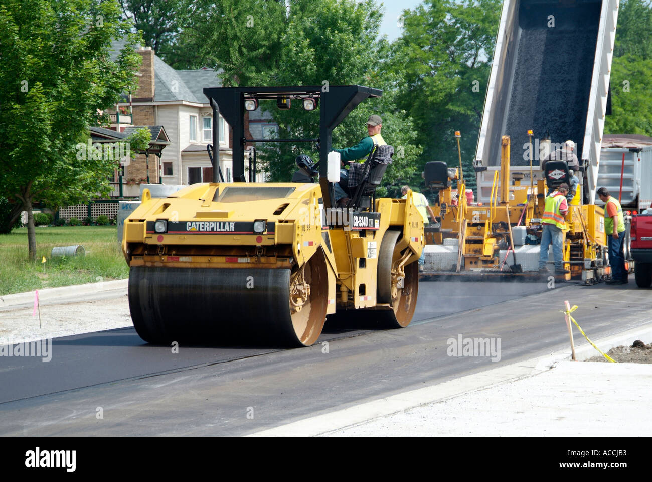 Steam roller Construction crew creates new asphalt street Stock Photo
