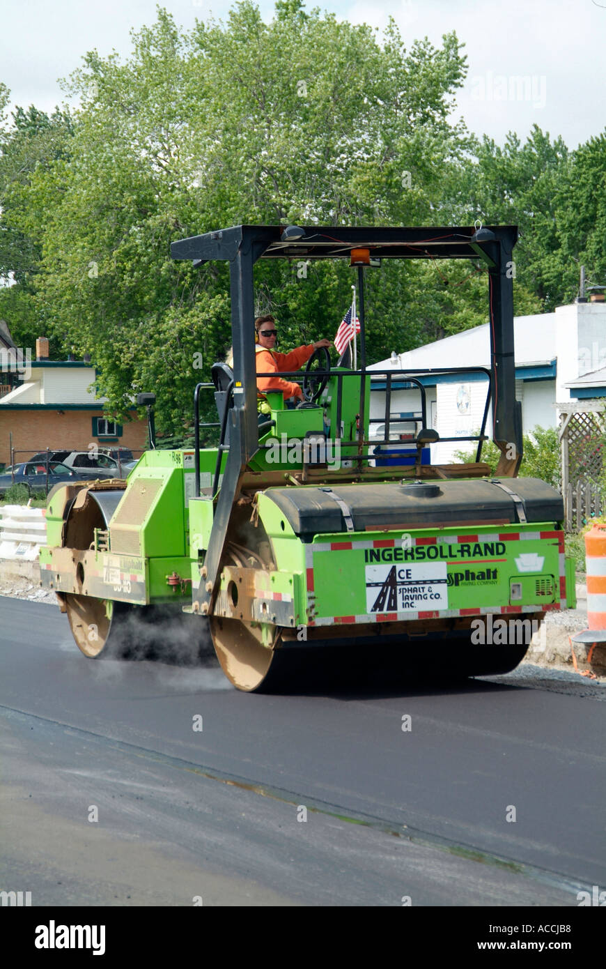 Steam roller Construction crew creates new asphalt street Stock Photo
