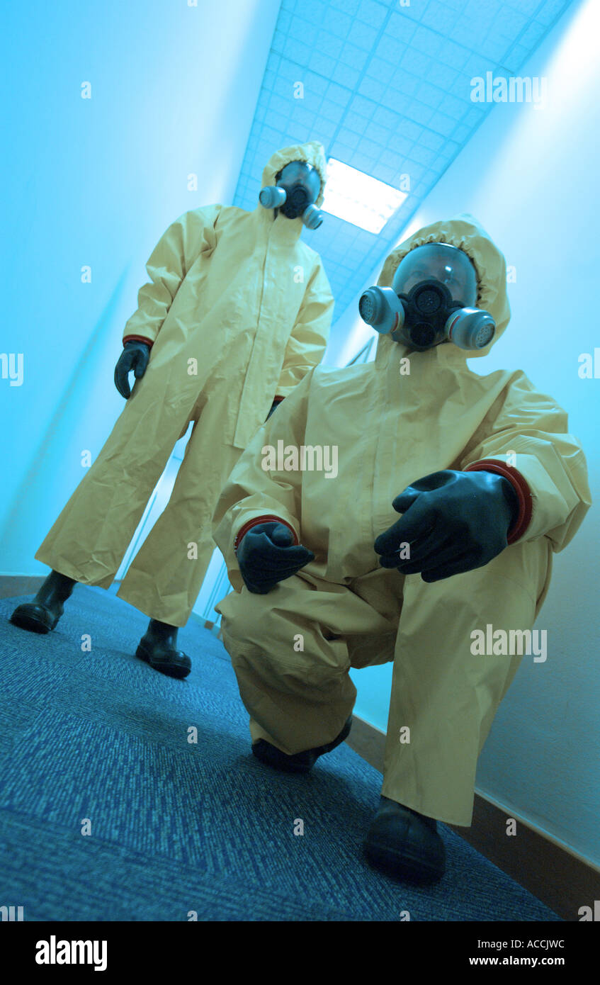 two men wearing NBC biological and chemical protection suits and gas masks Stock Photo