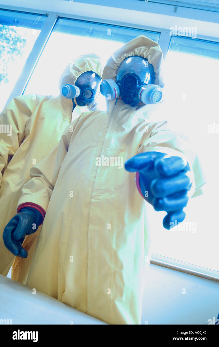 two men wearing NBC biological and chemical protection suits and gas masks Stock Photo
