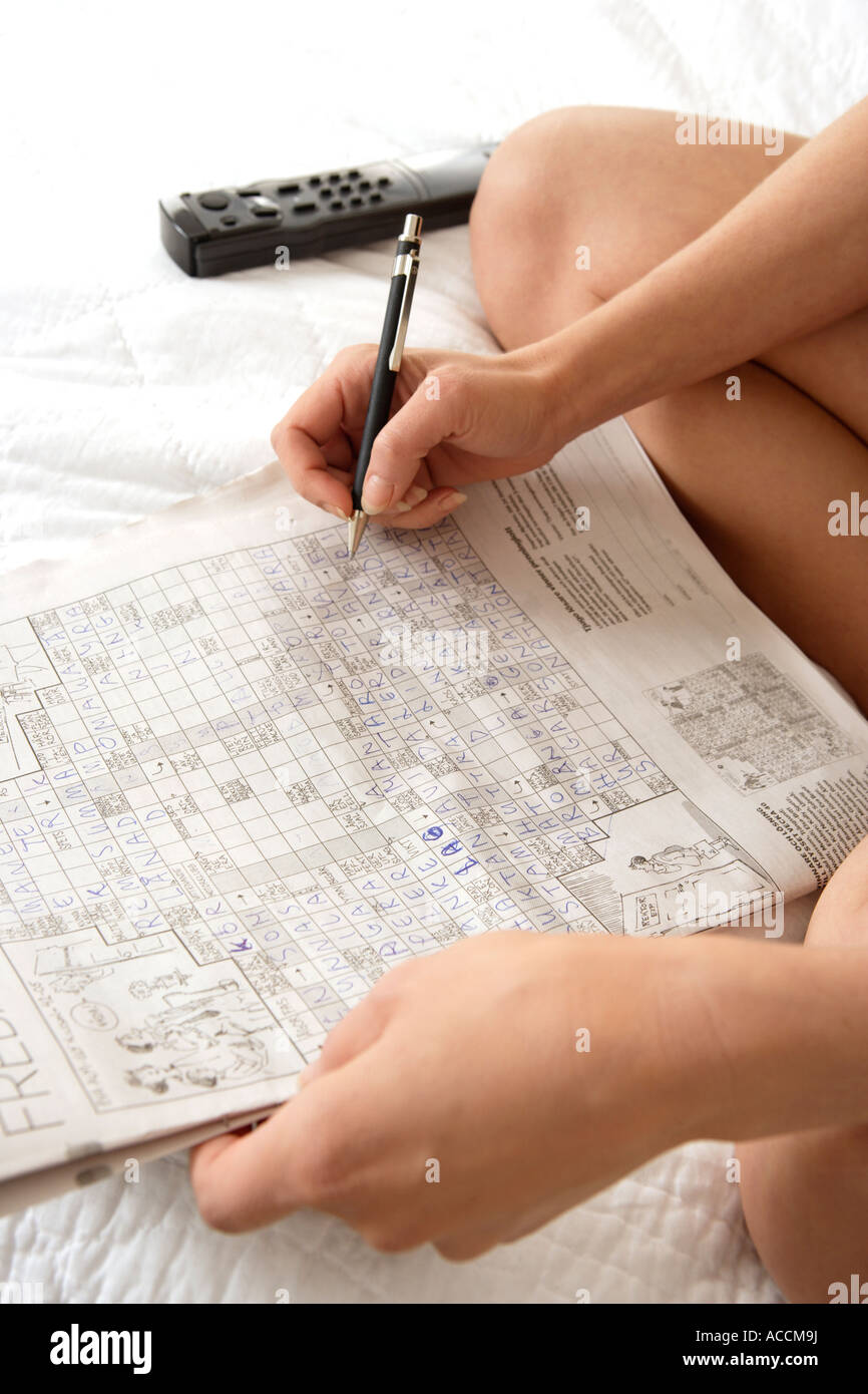 A person solving a crossword puzzle Stock Photo Alamy A person solving a crossword puzzle Stock Photo Alamy