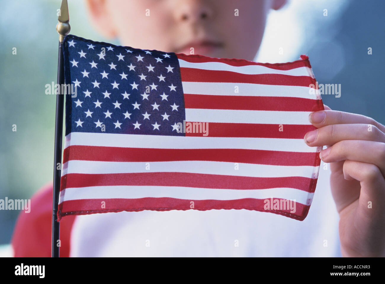 Nine year old girl holding American flag Stock Photo - Alamy