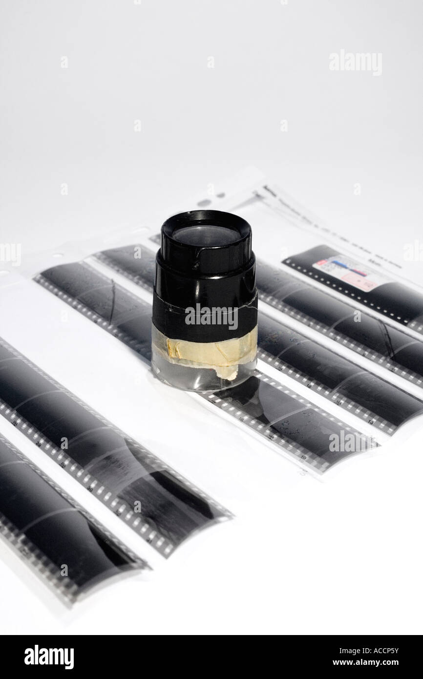 A magnifying glass and negatives Stock Photo Alamy