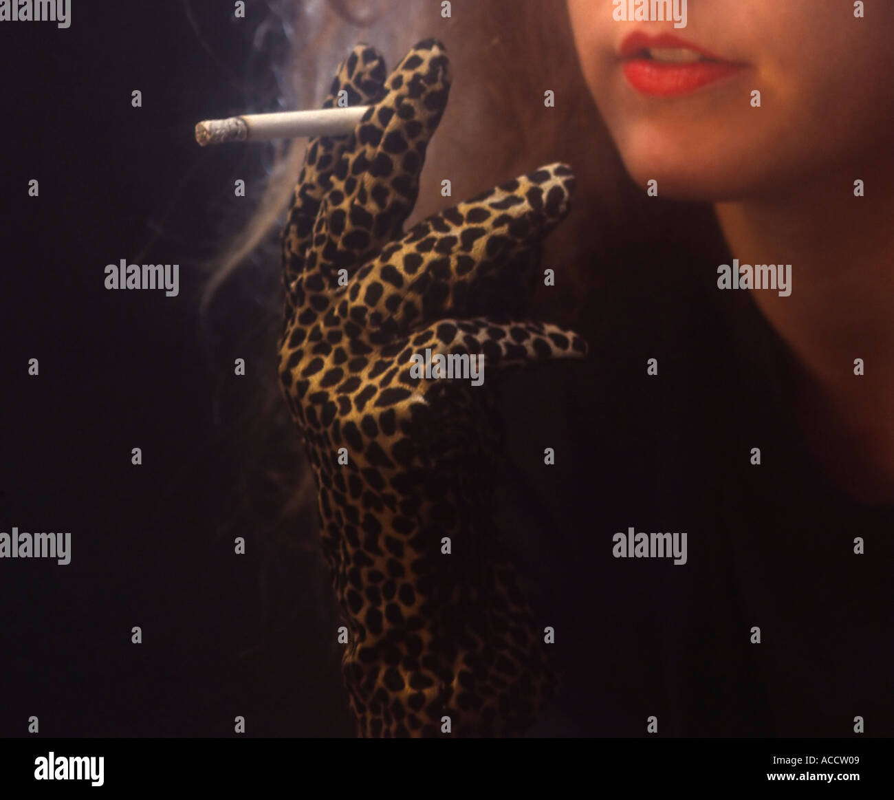 MR young woman with cloves with leopad pattern smoking a cigarette