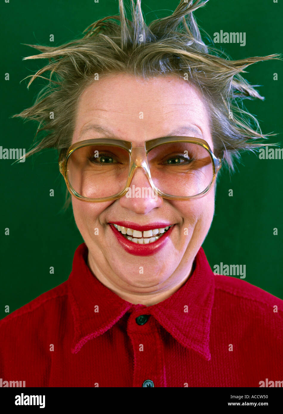 MR woman with tousled hair and big spectacles grinning Stock Photo
