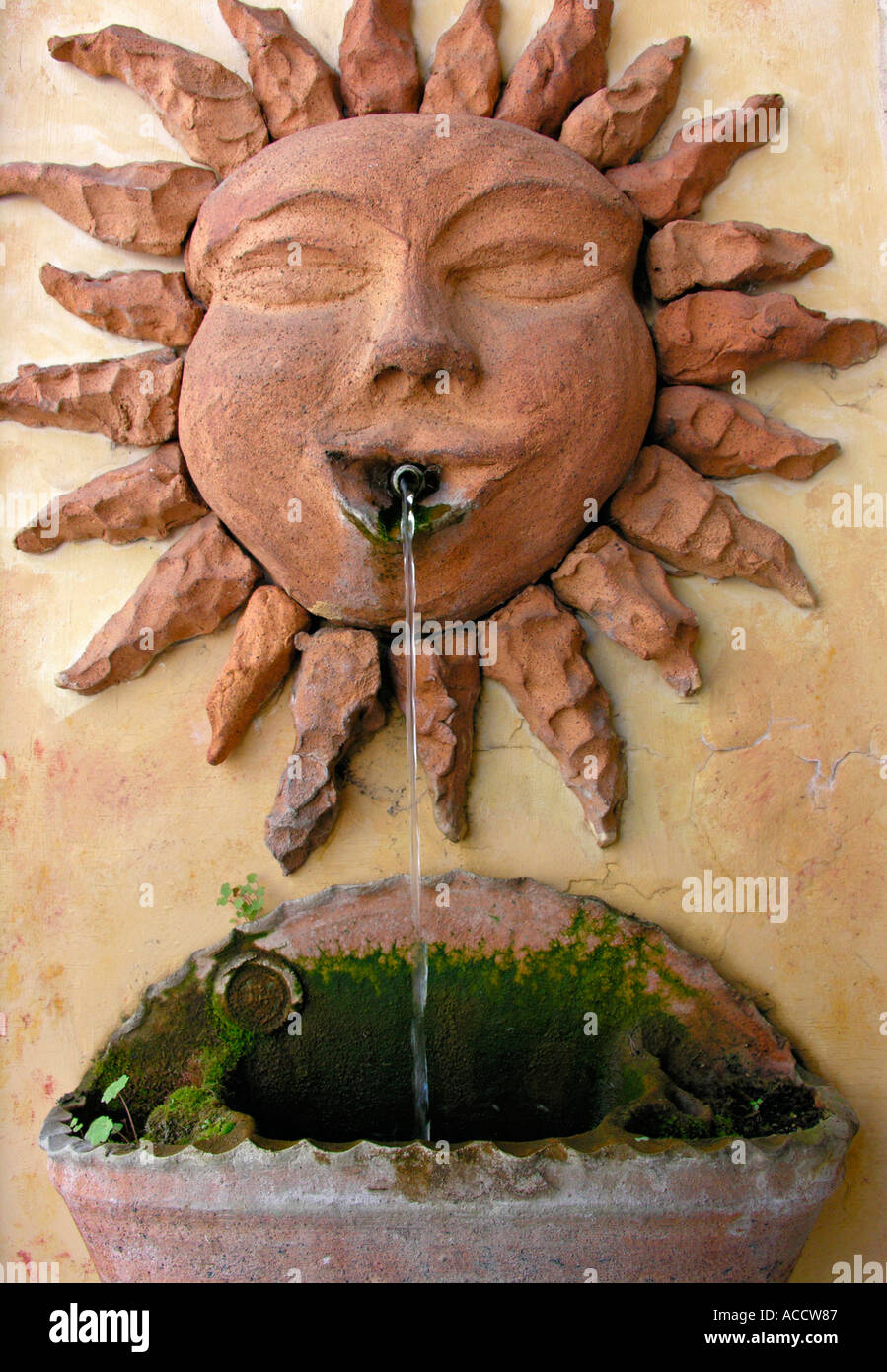 fountain well gargoyle with sun face Stock Photo Alamy