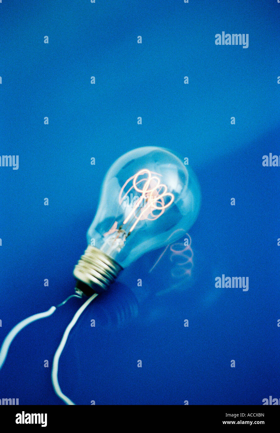 A light bulb on a blue background Stock Photo - Alamy