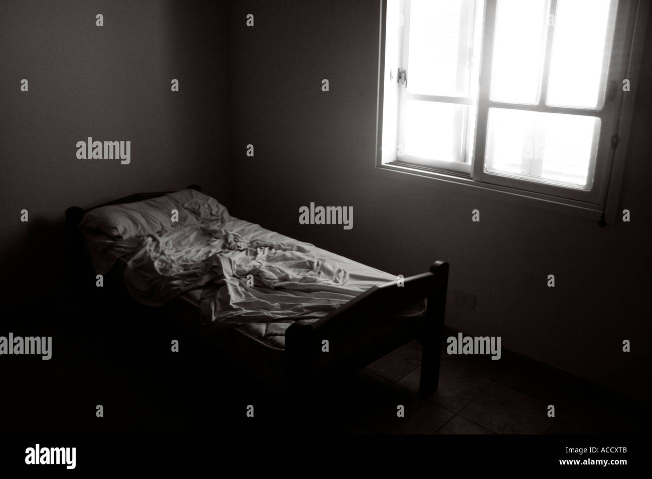 Single bed unmade in white room Stock Photo