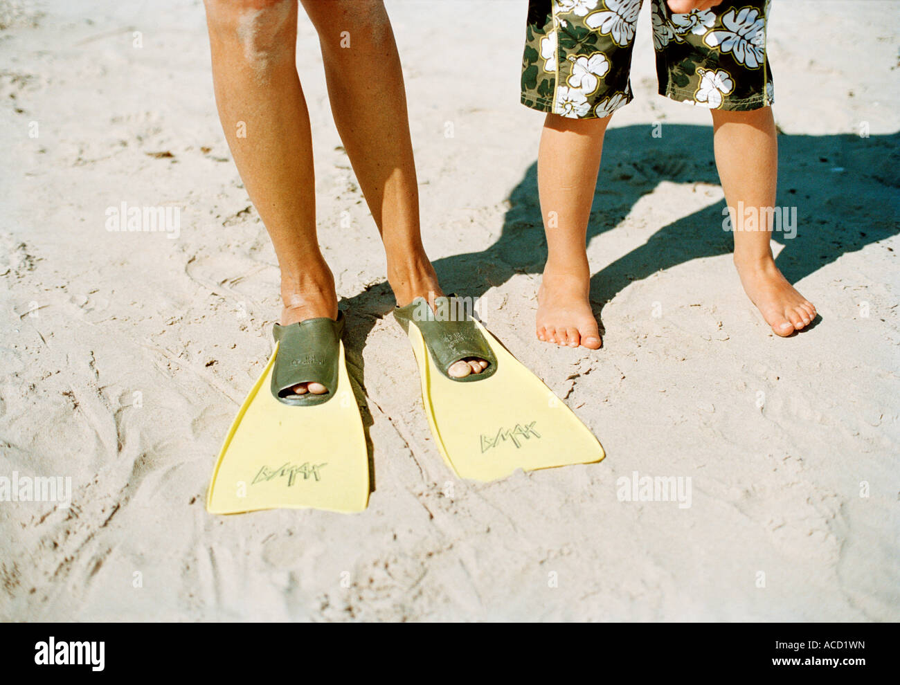 Diving flippers and bare feet on a beach Stock Photo Alamy