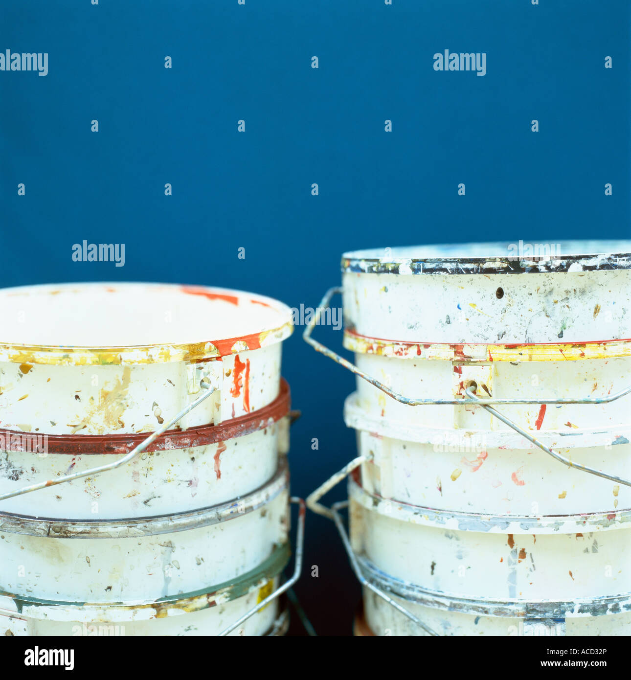 Empty paint buckets on a blue background Stock Photo Alamy