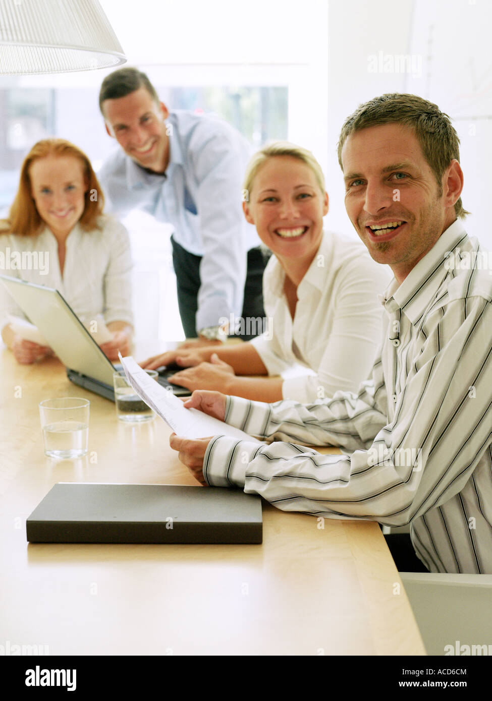 Two women and two men in an office Stock Photo - Alamy