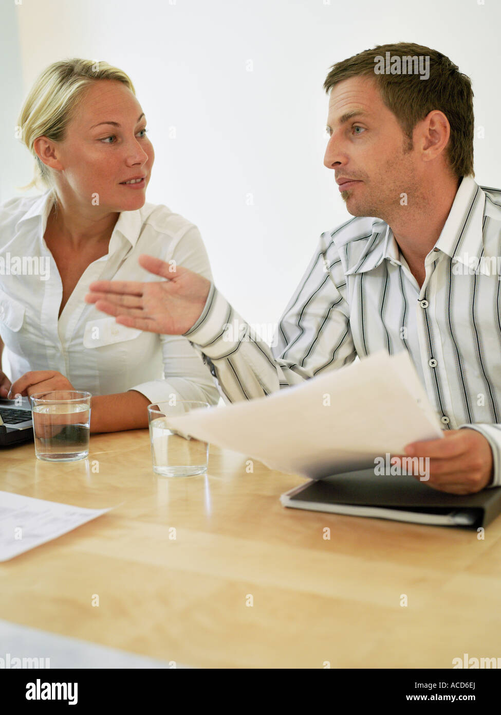 A man and a woman discussing during a meeting Stock Photo - Alamy