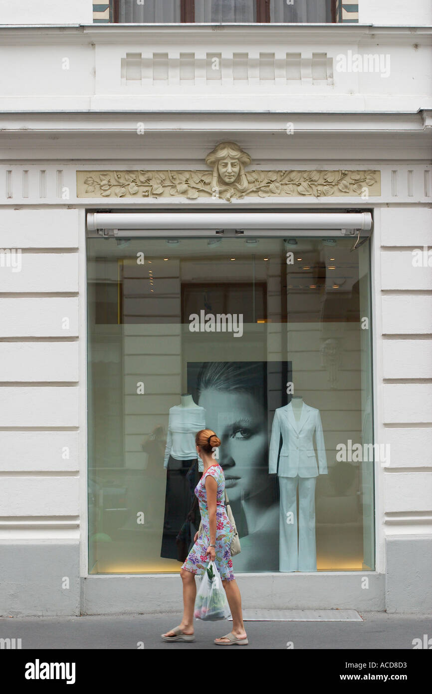 Woman passinf shop window in the Miklosiceva cesta road in Ljubljana Laibach Slovenia Stock Photo