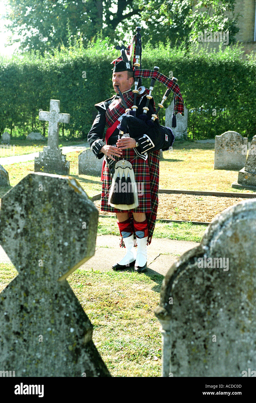 Bagpipe player in graveyard Stock Photo Alamy
