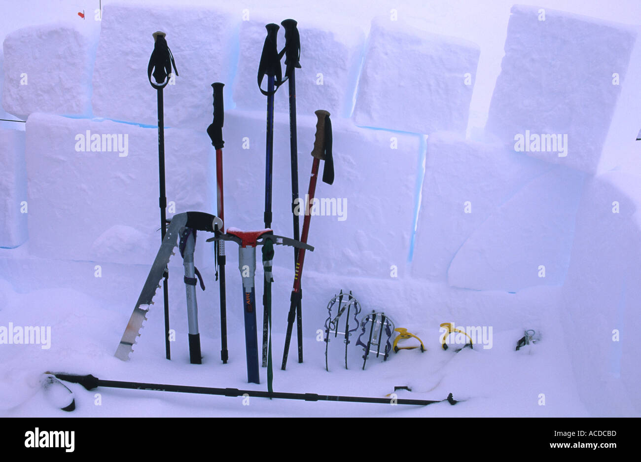Mountaineering equipment partially buried by spindrift Stock Photo