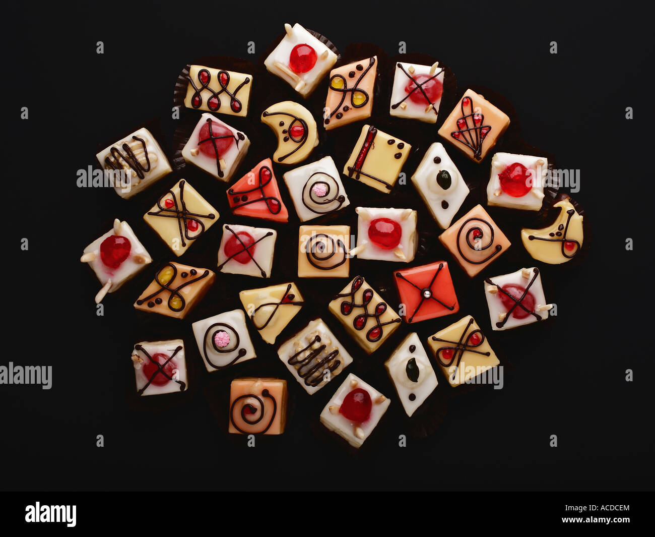 Petit fours on black background Stock Photo Alamy
