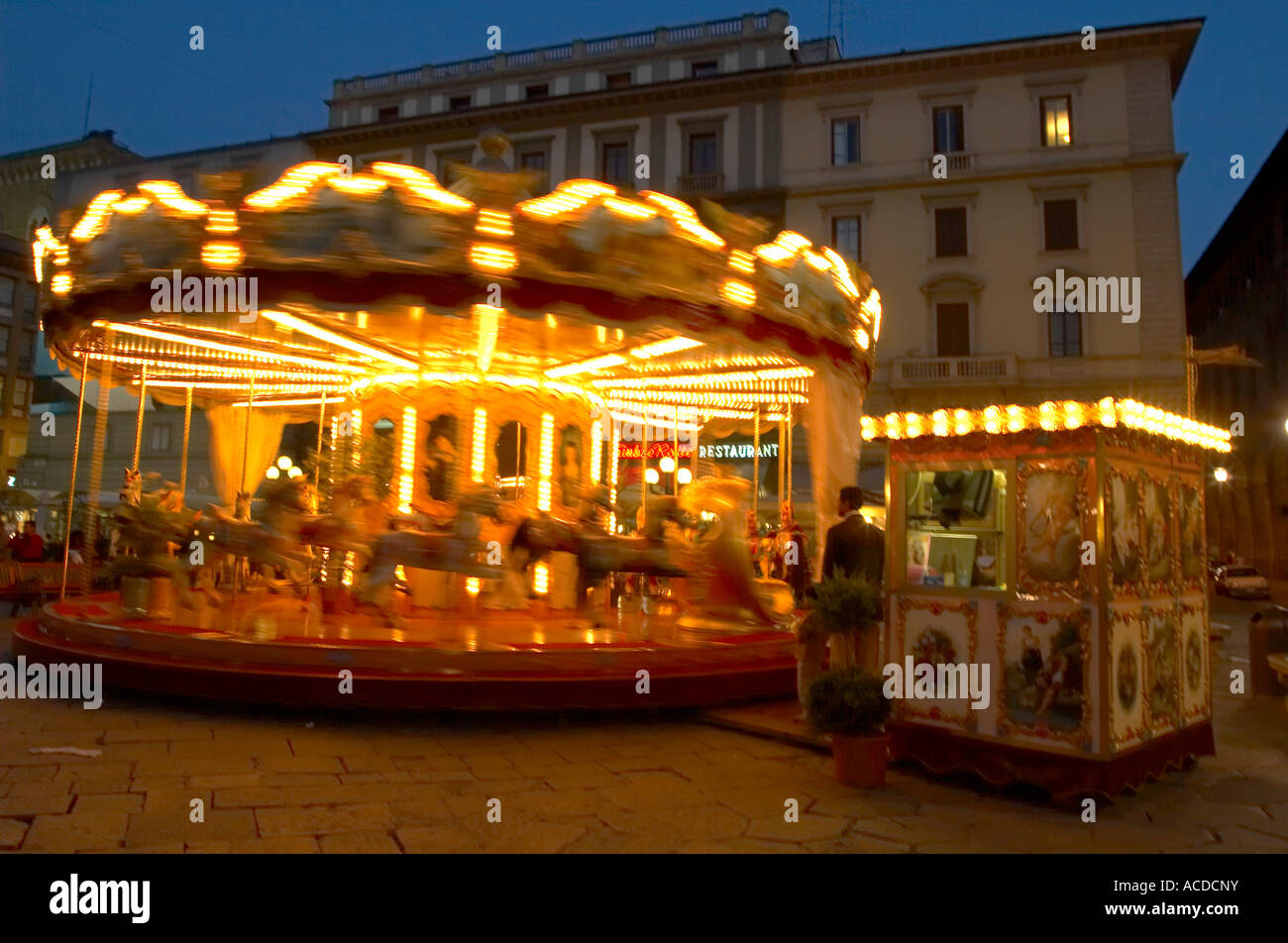 Carousel in a piazza in Florence Italy with old buildings behind it