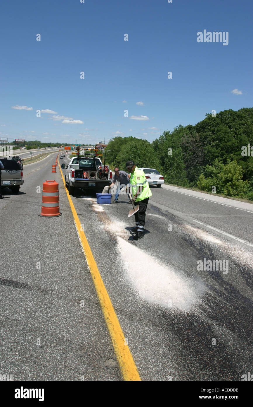 Traffic accident Tow truck workers are cleaning up spilled anti freeze on the road. Kansas City, MO, USA. Stock Photo