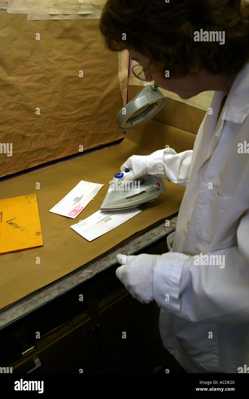 Fingerprint expert using the heat in iron to develop fingerprints on