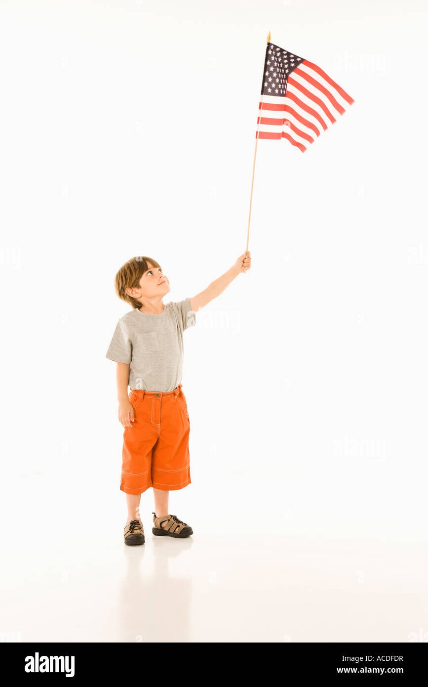 Boy holding American flag against white background Stock Photo