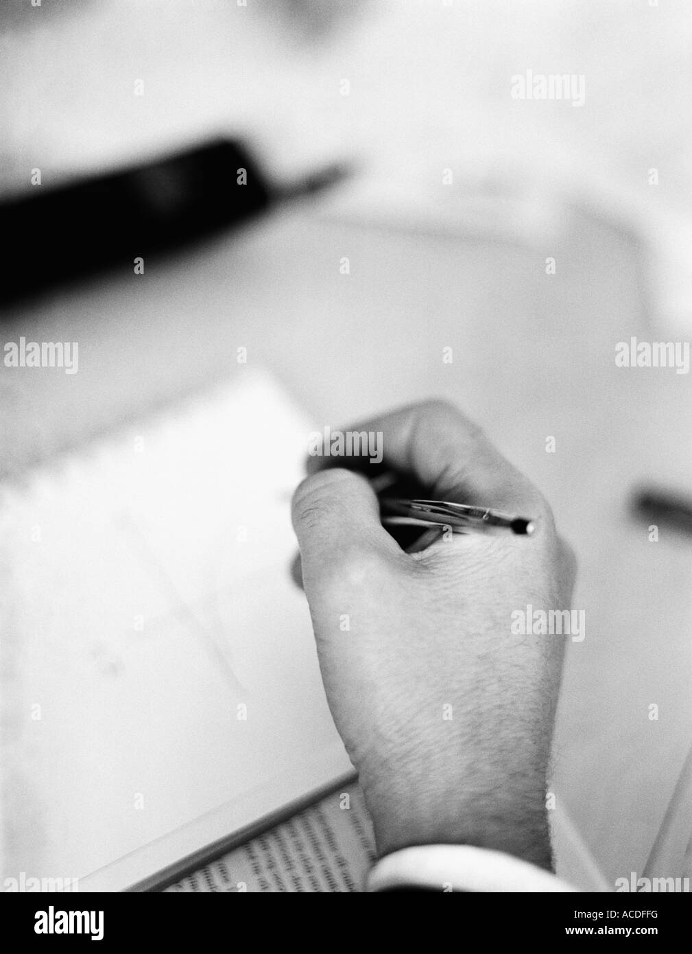 A hand holding a pen close-up BW Stock Photo - Alamy