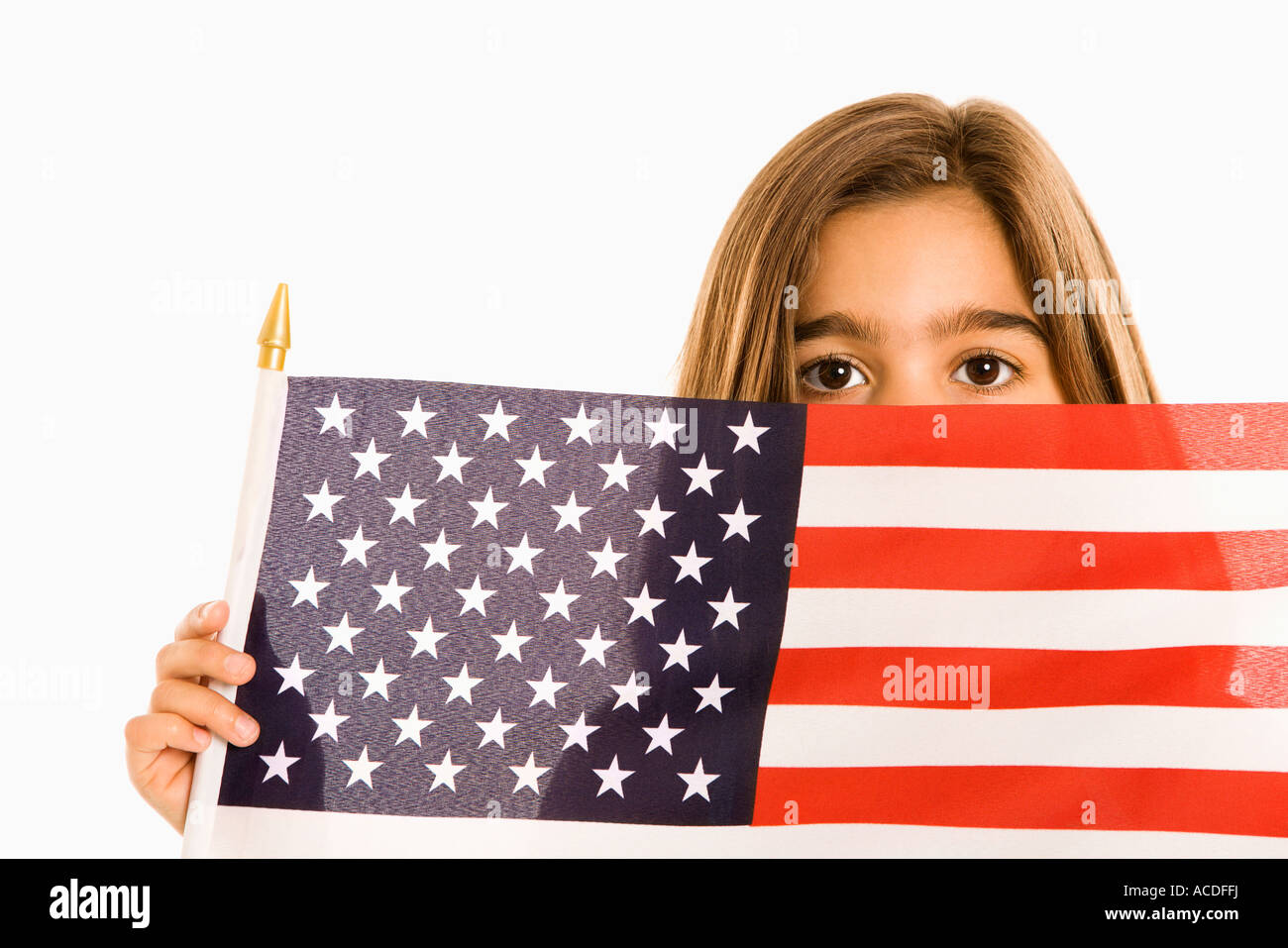 Girl peeking over American flag against white background Stock Photo ...