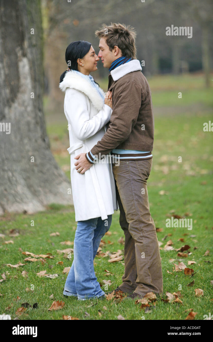 A young couple is kissing in the autumn forest lifestyle Stock Photo ...