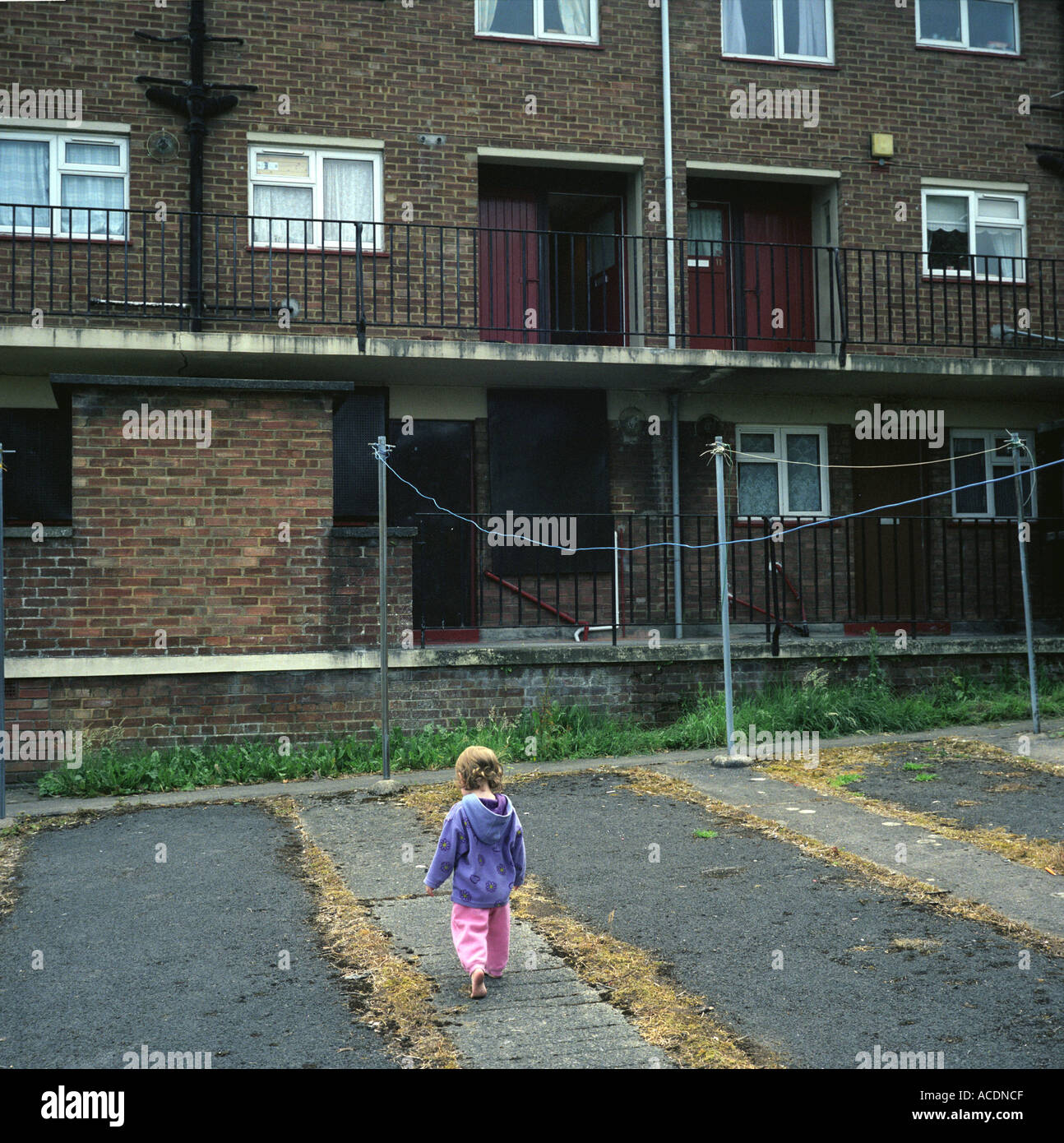 A young girl playing in a council estate in Bristol, UK. Stock Photo