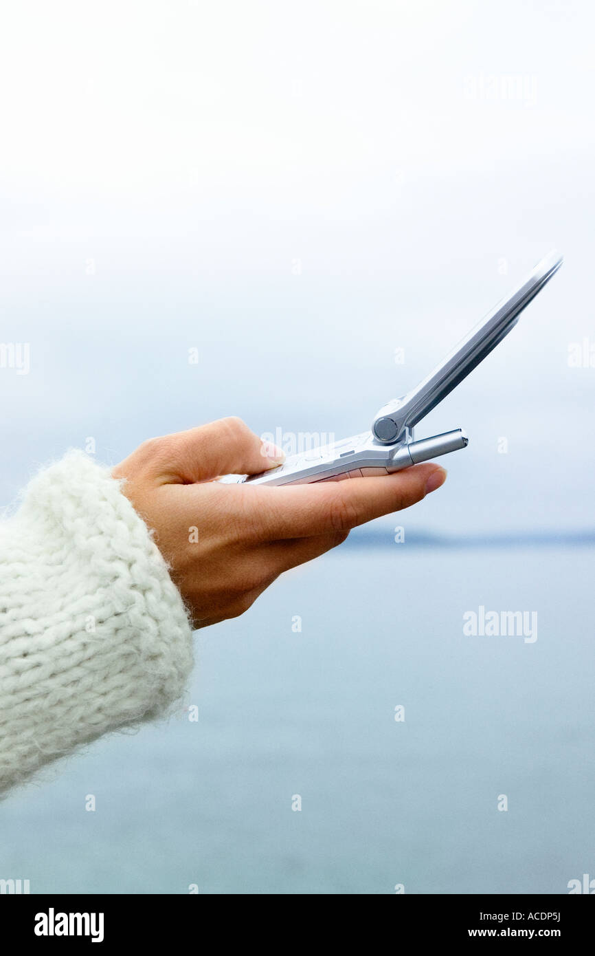 A hand holding a mobile phone close-up. Stock Photo