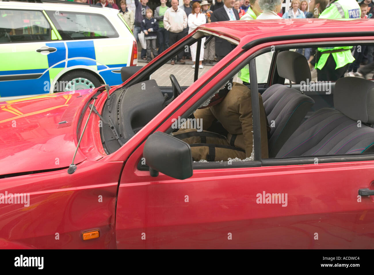 car crash with crash test dummy behind the wheel and police car Stock