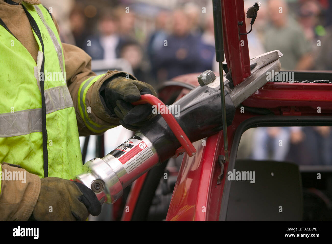 Fireman using the Jaws of Life to gain access to a car crash victim ...