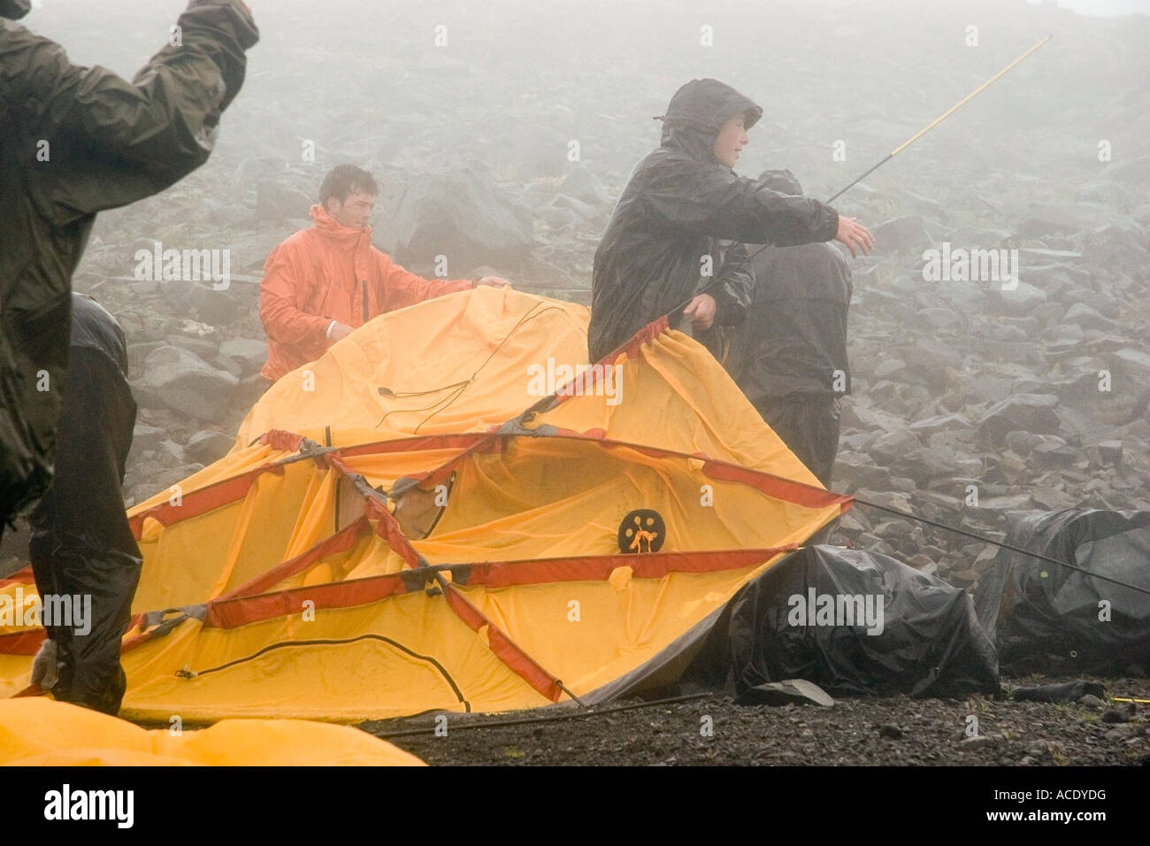 Backpackers put up tent in the rain Lost Lake Chugach National Forest Kenai Peninsula Alaska
