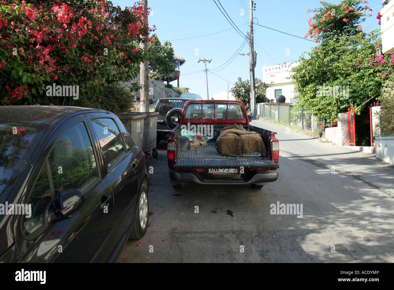 Badly parked cars in the old part of Platanias, Crete, Greece. Stock Photo