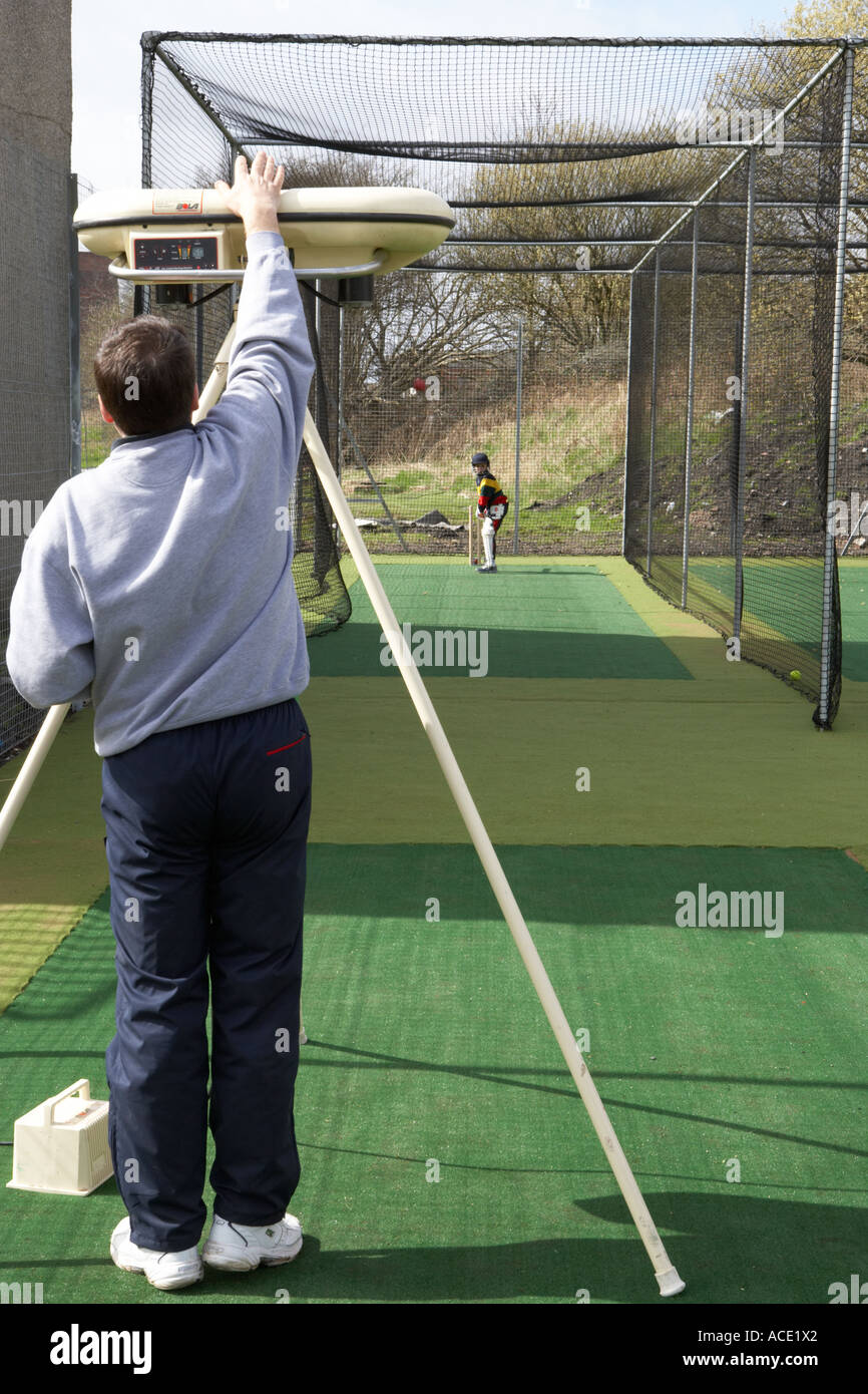 using a bowling machine during cricket practice Stock Photo Alamy