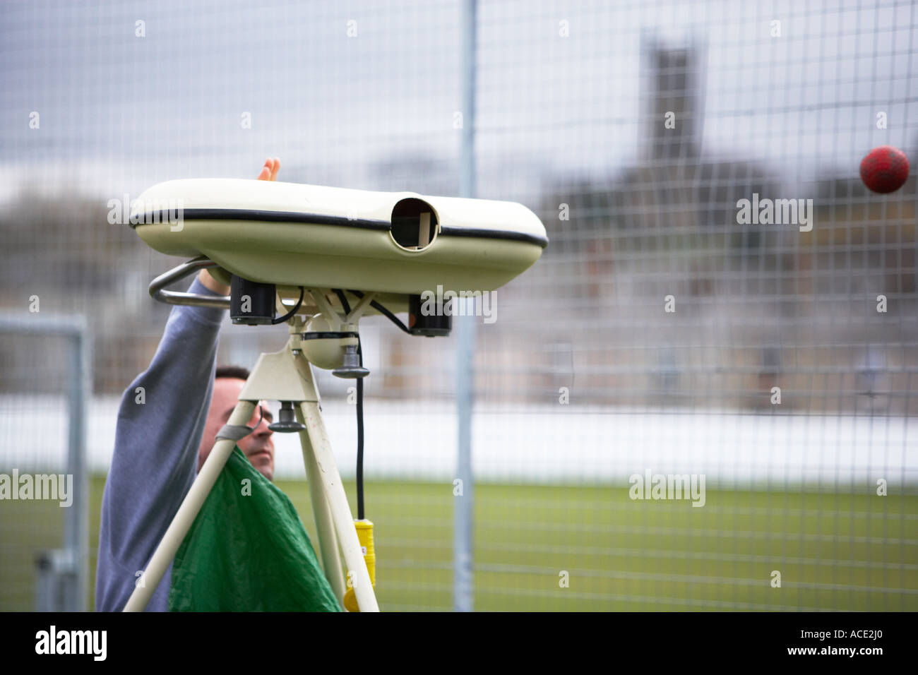 using a bowling machine during cricket practice Stock Photo