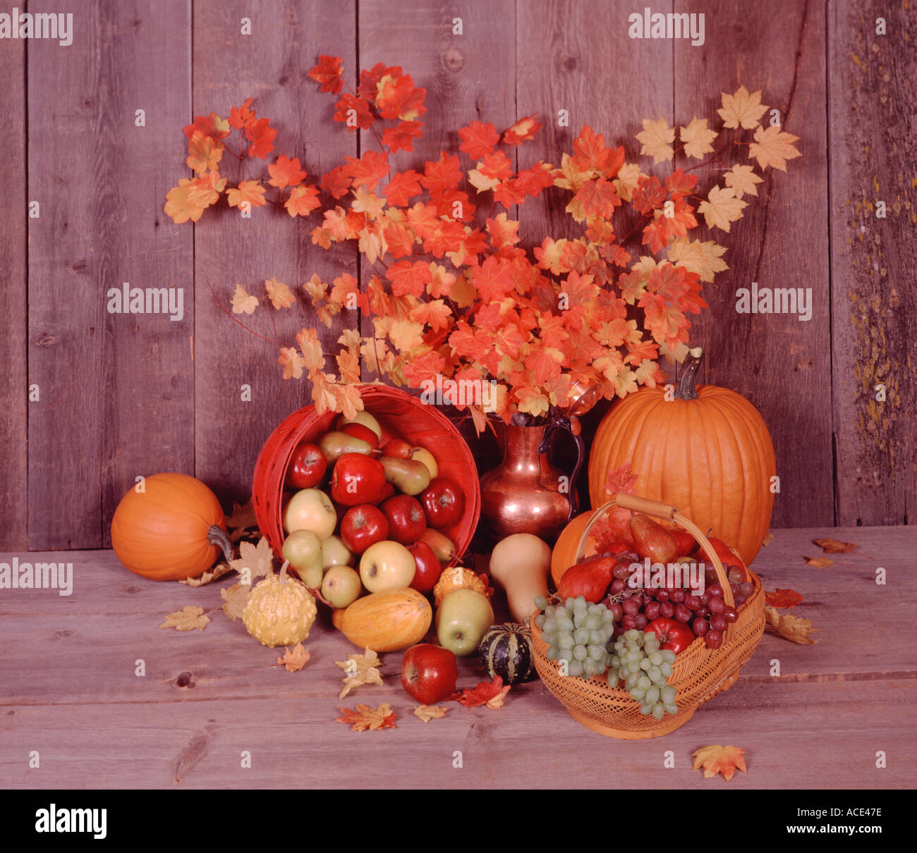Harvest still life with a basket of autumn fruits and vegetables on an ...
