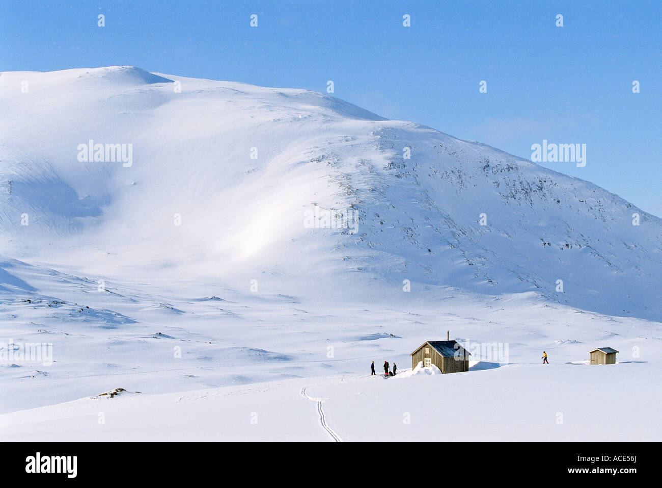A mountain cabin in mountains covered in snow Stock Photo - Alamy