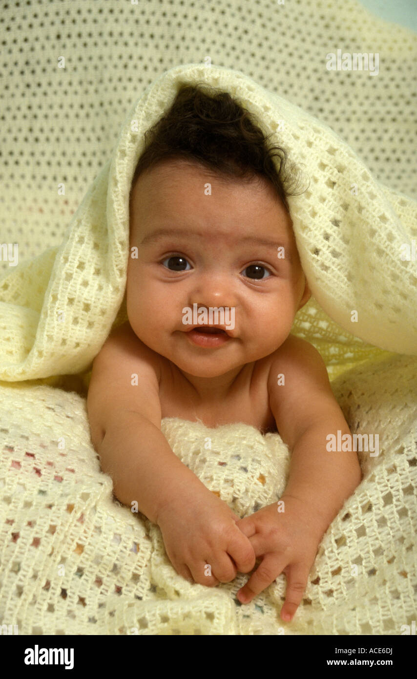 Cute Studio Portrait Mixed Race Black Baby Under Yellow Towel Stock
